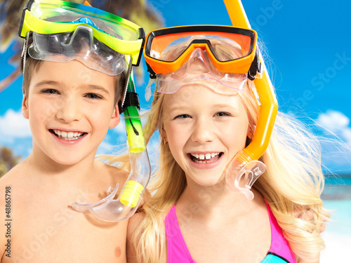 Photo: Portrait of the happy children enjoying at beach Portrait of the happy children enjoying at beach