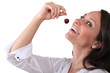 Woman eating a cherry