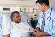 Doctor Using Digital Tablet In Consultation With Senior Patient