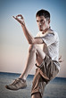 Young attractive man making Thai-chi movements