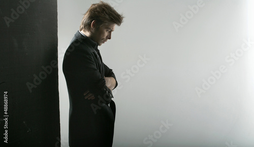 Photo: Thoughtful handsome guy staring at the floor Thoughtful handsome guy staring at the floor