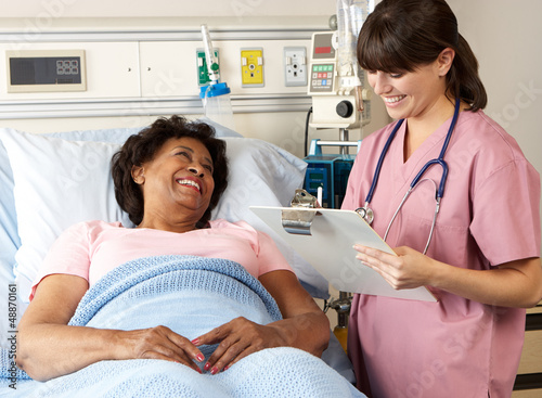 Photo: Nurse Visiting Senior Female Patient On Ward Nurse Visiting Senior Female Patient On Ward