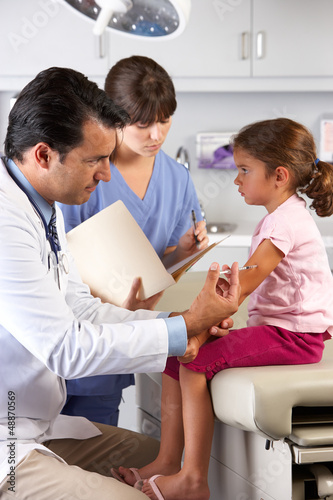 Photo: Doctor Giving Child Injection In Doctor's Office Doctor Giving Child Injection In Doctor's Office