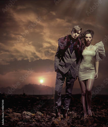 Photo: Young couple over sunset background Young couple over sunset background