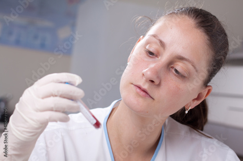 Photo: Holding test tube full of blood Holding test tube full of blood