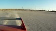 Red car speed drift on sand