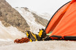 The tired climber has rest in tent with feet outside