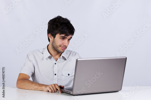 Photo: Young working with his laptop Young working with his laptop