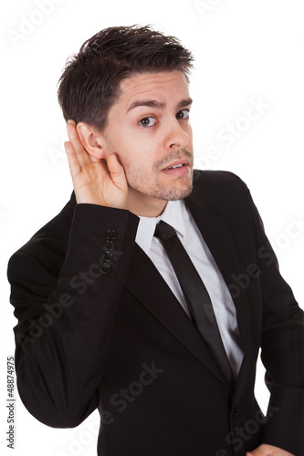 Photo: Businessman holding his hand to his ear Businessman holding his hand to his ear
