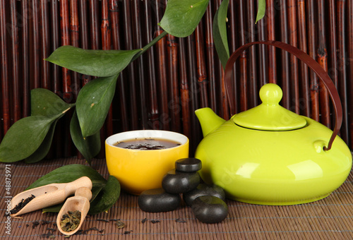 Photo: Chinese tea ceremony on bamboo table on bamboo background Chinese tea ceremony on bamboo table on bamboo background