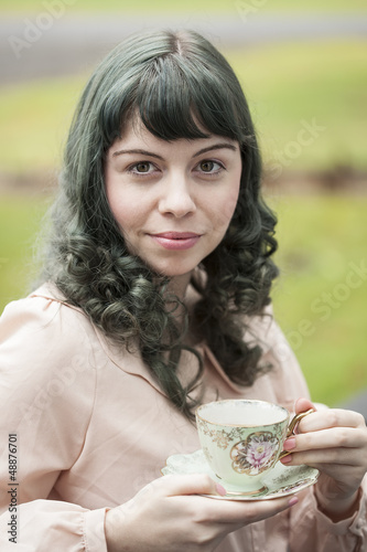 Photo: Young Woman with Antique Tea Cup Young Woman with Antique Tea Cup