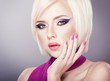 Beautiful woman with bright violet purple makeup and manicure
