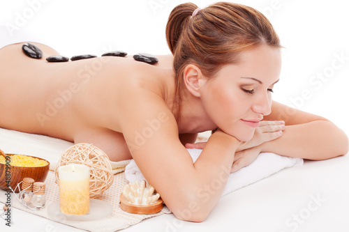 Photo: woman receiving spa stones therapy woman receiving spa stones therapy