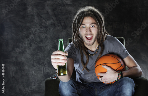 Photo: Basketballl fan watching television Basketballl fan watching television