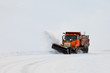 Photo: Snow plough clearing road in winter storm blizzard Snow plough clearing road in winter storm blizzard
