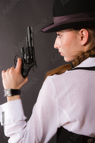 Photo: Portrait of beautiful young woman with a gun. Portrait of beautiful young woman with a gun.