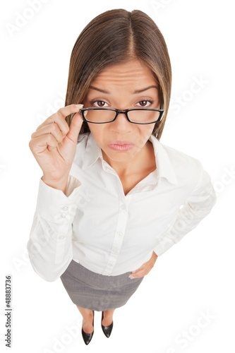 Photo: Suspicious angry secretary taking off her glasses Suspicious angry secretary taking off her glasses