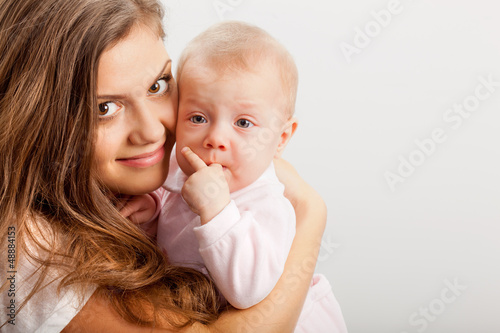 Photo: young mother holding her baby girl on hands young mother holding her baby girl on hands