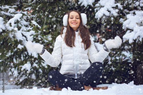 Photo: woman sitting in winter park woman sitting in winter park