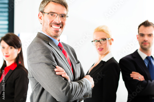 Photo: Business - group of businesspeople in office Business - group of businesspeople in office
