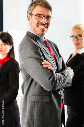 Photo: Business - group of businesspeople in office Business - group of businesspeople in office