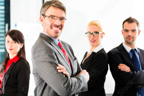 Photo: Business - group of businesspeople in office Business - group of businesspeople in office