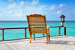 beach chair on balcony with view over blue ocean