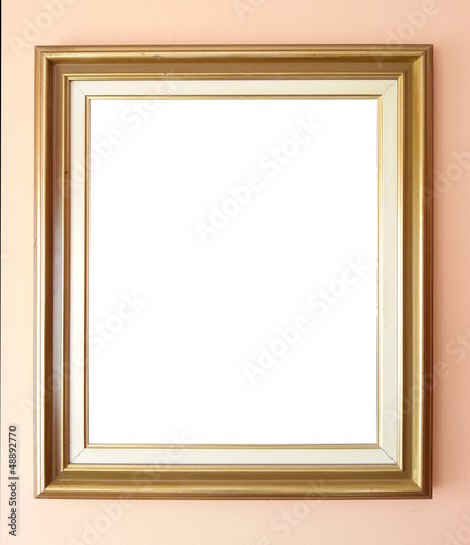 Photo: Empty golden frame on wall Empty golden frame on wall