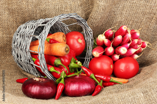 Photo: fresh red vegetables on sackcloth background fresh red vegetables on sackcloth background