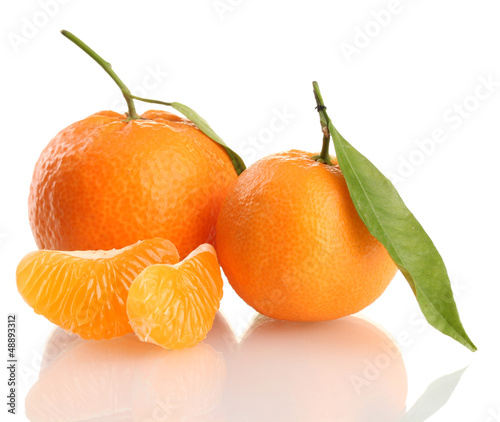 Photo: Ripe sweet tangerine with leaves, isolated on white Ripe sweet tangerine with leaves, isolated on white