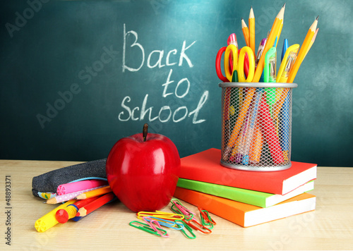 Photo: Back to school - blackboard with pencil-box and school Back to school - blackboard with pencil-box and school