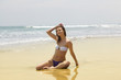 beautiful girl sunbathes on an ocean coast