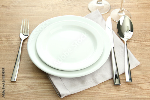 Photo: Table setting on wooden table Table setting on wooden table