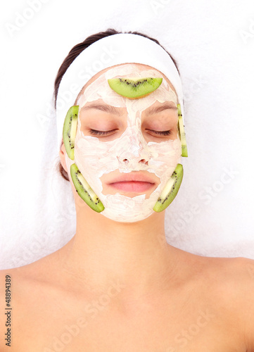 Photo: Young woman with clay facial mask Young woman with clay facial mask