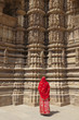 Woman in red sari at Khajuraho Temple.