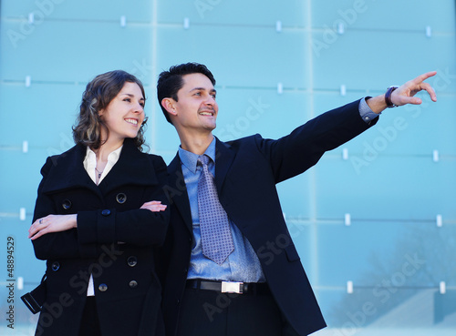 Photo: A couple of young Caucasian business persons in formal clothes A couple of young Caucasian business persons in formal clothes