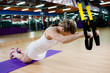 Young fit woman does suspension training