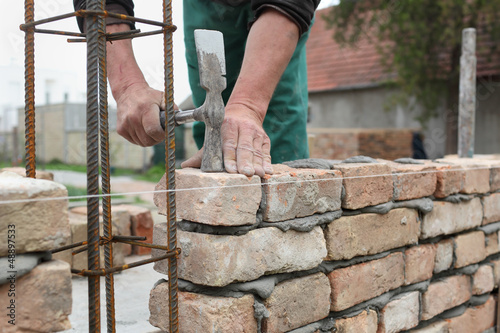 Photo: Mason making wall with mortar and bricks Mason making wall with mortar and bricks