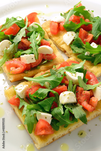 Photo: Focaccia with tomatoes, rocket and mozzarella Focaccia with tomatoes, rocket and mozzarella