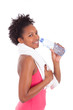 Young african american   fitness woman drinking water