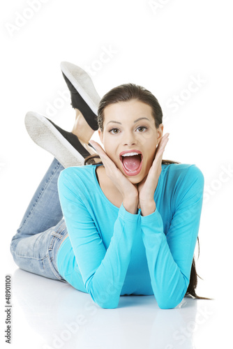 Photo: Happy woman in casual clothes lying on floor Happy woman in casual clothes lying on floor