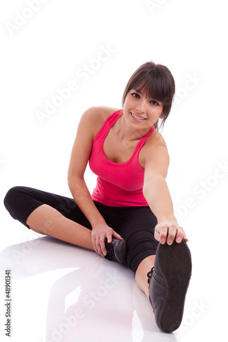 Photo: Fitness woman stretching her leg to warm up Fitness woman stretching her leg to warm up