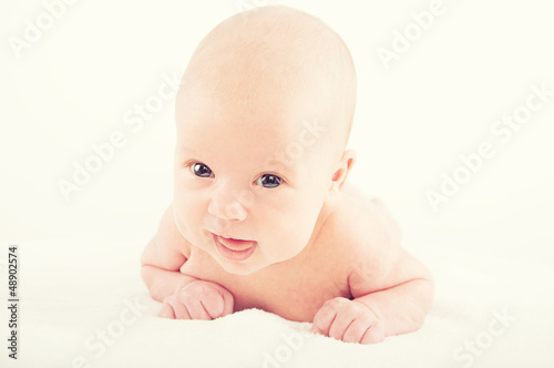 Photo: happy naked newborn baby on white background happy naked newborn baby on white background