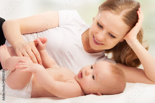 Photo: Happy family. young mother and baby rests Happy family. young mother and baby rests