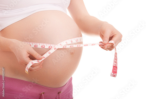Photo: belly of pregnant woman measurement of tape belly of pregnant woman measurement of tape