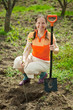 Mature woman planting tree