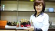 Woman-cosmetician represents nail polishes