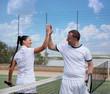 Couple handshaking at the tennis court after a match 