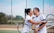 Couple handshaking at the tennis court after a match 