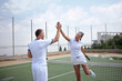 Couple handshaking at the tennis court after a match 